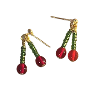 a pair of earrings with red and green beads