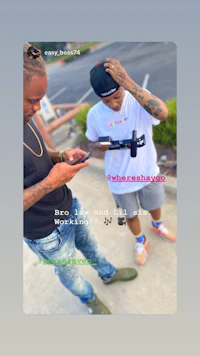 a man sitting on top of a graffiti covered wall