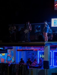 a group of people on stage at a bar at night
