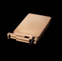 a gold cigarette lighter on a black background
