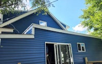 a blue house with white siding and a blue door