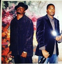 two men in suits standing next to each other
