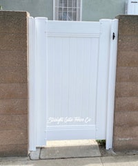 a white gate in front of a house
