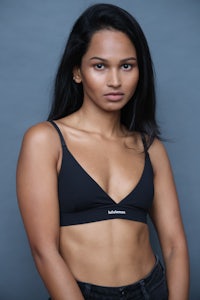 a woman in a black bikini top posing for a photo
