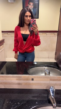a woman taking a selfie in a bathroom