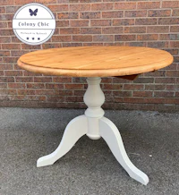 a white table with a wooden top and a wooden base