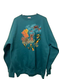 a green sweatshirt with an image of a deer on it