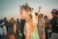 a group of people dancing on a beach