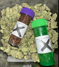 two green and purple jars with marijuana in them