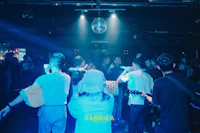 a group of people dancing at a nightclub