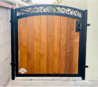 a wooden gate with wrought iron accents