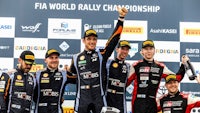 a group of racers standing on a podium
