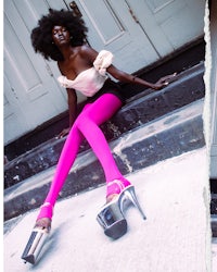 a woman in pink tights sitting on steps