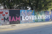 a mural of miami loves artists on a wall