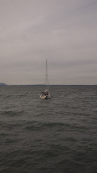 a sailboat floating in the ocean
