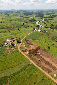 an aerial view of a farm and a river