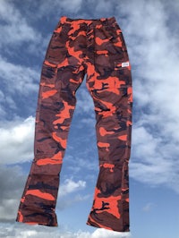 a pair of orange and black camouflage pants
