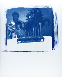 a blue photo of a family with a christmas tree
