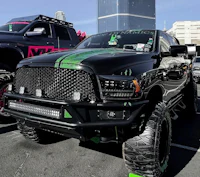 a black ram truck is parked in a parking lot