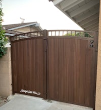 a brown wooden gate in front of a house