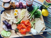 a wooden cutting board with various ingredients on it