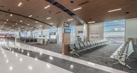 an airport with a long line of people waiting to check in