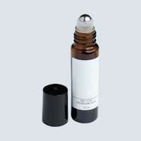 a bottle of essential oil with a black cap
