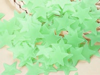a bunch of green plastic stars in a basket
