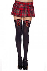 a woman in a plaid skirt and black stockings
