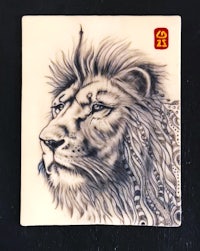 a ceramic tile with a lion's head on it