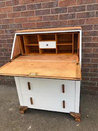 a white desk with a wooden top and drawers