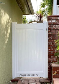 a white gate in front of a house