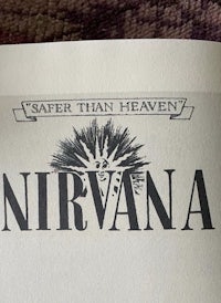 a book with the words safer than heaven nirvana