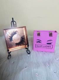 a pink box with a pair of false eyelashes next to it