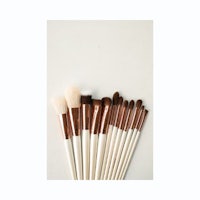 a set of makeup brushes on a white surface