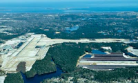 an aerial view of an airport near a lake