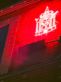 a red neon sign on the side of a building