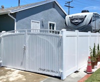 a white rv is parked in front of a house