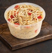 pasta in a plastic container with tomatoes and peppers
