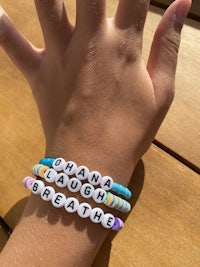 a girl's hand with a bracelet with her name on it