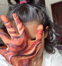 a girl with a hand painted with a zebra pattern