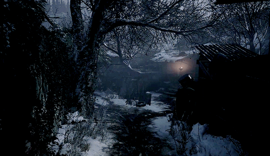 a dark alley with trees and a lamp in the background