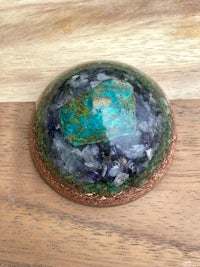 a turquoise stone on top of a wooden table