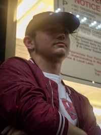 a man wearing a burgundy jacket