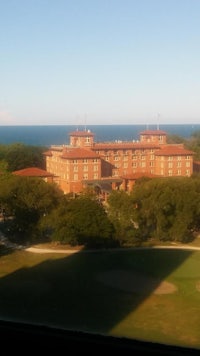 a view of a golf course from a window of a hotel