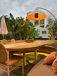 a patio with a table and chairs and a large umbrella