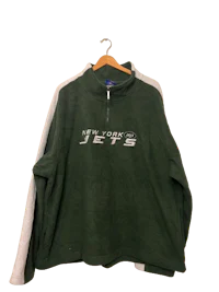 a green and white jacket with the new york jets logo on it