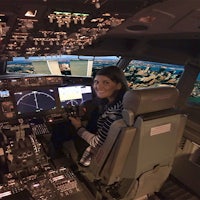 a woman sitting in the cockpit of an airplane