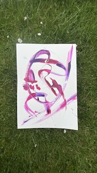 a painting with purple and pink paint on the grass