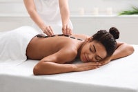 a woman getting a back massage at a spa